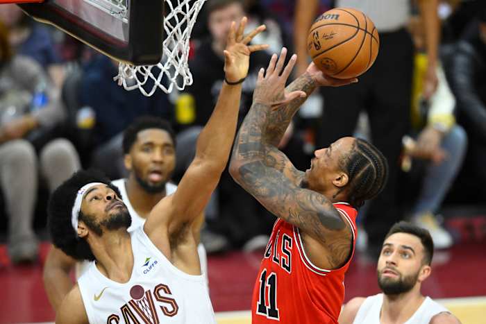 Jan 15, 2024; Cleveland, Ohio, USA; Chicago Bulls forward DeMar DeRozan (11) shoots beside Cleveland Cavaliers center Jarrett Allen (31) in the fourth quarter at Rocket Mortgage FieldHouse.
